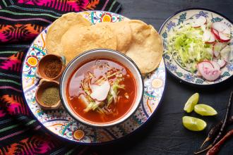 Mexican red pozole on dark background