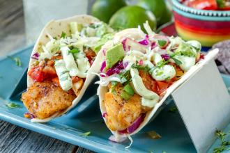 Two fish tacos in taco holder