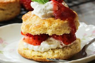 Strawberry shortcake with stuffed cream topping on a plate 