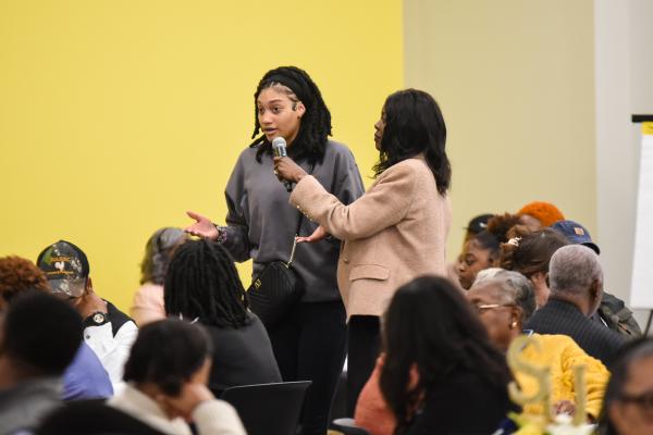 Dr. Jacobs-Young engaging with a community member at a Building a Healthy Community Together engagement and listening session.